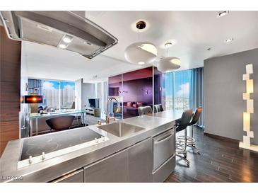 Modern kitchen boasts stainless steel appliances, a sleek countertop, and stylish lighting fixtures at 4381 W Flamingo Rd # 1901, Las Vegas, NV 89103