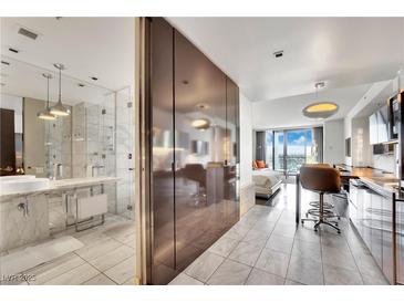 Contemporary condo featuring a marble bathroom, modern kitchen, and a comfortable bedroom with city views at 4381 W Flamingo Rd # 1903, Las Vegas, NV 89103