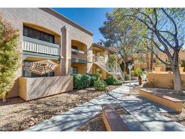 Beautiful condo community featuring landscaped grounds, walkways, and charming exterior architecture at 5138 S Jones Blvd # 207, Las Vegas, NV 89118
