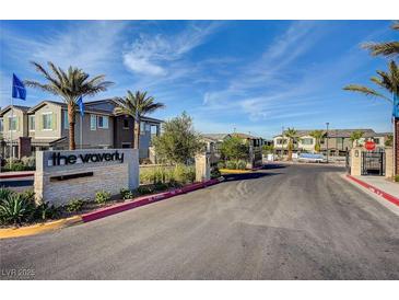 View of the Waverly community entrance with palm trees and desert landscaping, showcasing a welcoming environment at 965 Nevada State Dr # 38202, Henderson, NV 89002