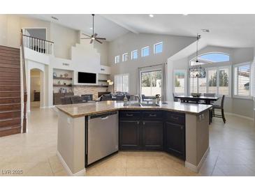 Spacious kitchen featuring a center island, stainless steel appliances, and an open layout to the living area at 10500 Pacific Palisades Ave, Las Vegas, NV 89144