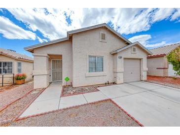 Single story home with a neutral colored stucco exterior, desert landscaping, and an attached single car garage at 2029 Rose Coral Ave, Las Vegas, NV 89106