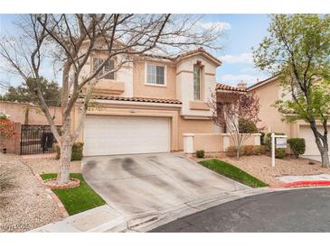 Two-story home with a two-car garage, desert landscaping, and a tile roof at 2057 Wandering Doe Ln, Las Vegas, NV 89134