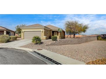 Charming single-story home featuring a two-car garage, landscaped yard, and desert landscape with a retaining wall at 2516 Evansville Ave, Henderson, NV 89052