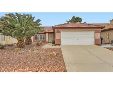 Charming single-story home featuring a well-maintained front yard and a two-car garage with a red tile roof at 3831 Flickering Star Dr, Las Vegas, NV 89103