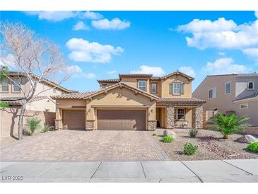 Charming two-story home featuring a three-car garage, desert landscaping and a welcoming stone-accented entrance at 508 Via Palermo Dr, Henderson, NV 89011