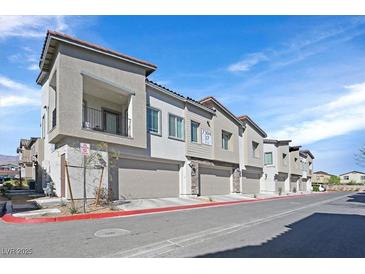 Charming townhome featuring a private balcony and attached one-car garage along a city street at 7304 N Decatur Blvd # 6, North Las Vegas, NV 89131
