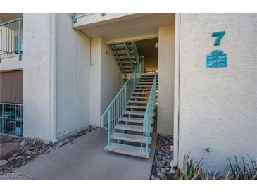 Exterior view of a stairway with light-green railings leading to upper units at 3550 Bay Sands Dr # 3056, Laughlin, NV 89029