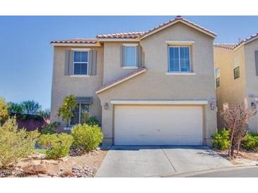 Two-story home showcasing a two car garage, desert landscaping and neutral colored stucco exterior at 4977 Vacaville Ave, Las Vegas, NV 89139