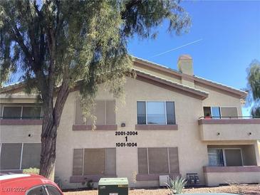 Multi-Gathering building with balconies and desert landscaping under a clear blue sky at 5710 E Tropicana Ave # 2003, Las Vegas, NV 89122