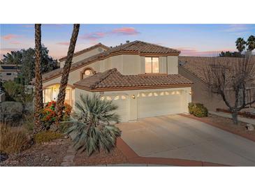 Charming home featuring a three-car garage and landscaped front yard at 8432 Squaw Valley Ave, Las Vegas, NV 89128