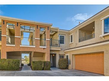 Lovely townhouse with a tandem garage and beautiful architecture details and professional landscaping at 10800 Amber Ridge Dr # 103, Las Vegas, NV 89144