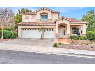 Charming two-story home with a well-manicured front yard and a three-car garage at 2020 Rainbow View St, Henderson, NV 89012