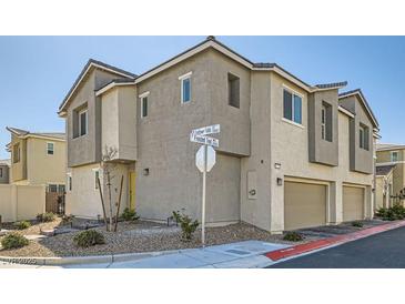 Contemporary two-story townhome with stucco siding, attached garages, and low-maintenance landscaping at 2773 Frosted Teal Ave, North Las Vegas, NV 89086