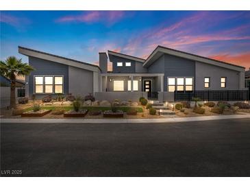 Stunning single-story home featuring modern design, xeriscaping, and a vibrant blue and gray color palette at 4345 N Dapple Gray Rd, Las Vegas, NV 89129