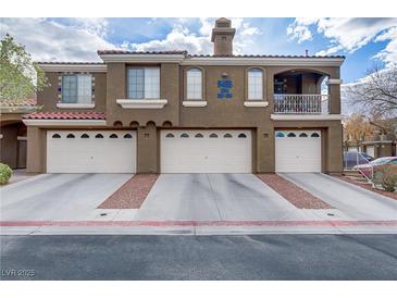 Charming multi-story townhome featuring multiple garage bays and a quaint balcony at 5465 Cardinal Ridge Ct # 103, Las Vegas, NV 89149
