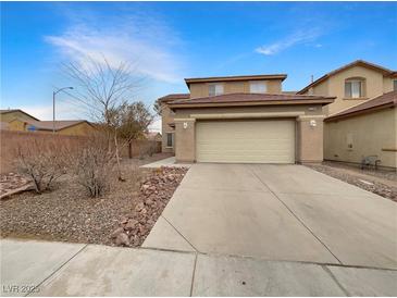Charming home featuring a two-car garage, low-maintenance landscaping, and a cozy, inviting facade at 6228 Grace Mountain St, Las Vegas, NV 89115