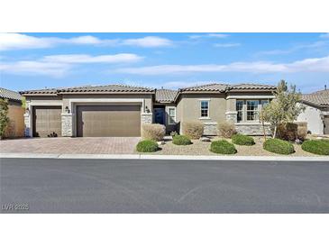 Charming single-story home featuring a three-car garage and beautifully landscaped front yard at 6232 Lautman Ridge Ct, Las Vegas, NV 89141