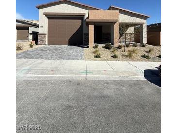 Charming single-story home with a well-manicured front yard and a welcoming entrance, plus a two car garage at 9956 Joshua Foothills St, Las Vegas, NV 89178