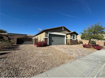 Charming single-story home with neutral stucco and brick accents, complemented by a manicured front yard at 2040 Port Royal Dr, Laughlin, NV 89029