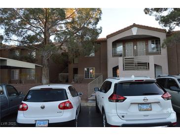 A multi-story condominium building featuring dual entrances and ample parking at 2121 Sealion Dr # 105, Las Vegas, NV 89128