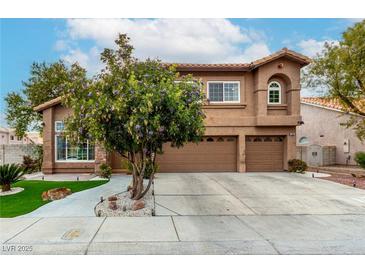 Charming two-story home with a well-manicured lawn, complemented by a three-car garage and inviting curb appeal at 4401 Lilac Glen Dr, Las Vegas, NV 89129