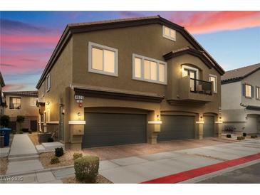 Stylish two-story home featuring a three-car garage, balcony, and well-maintained landscaping at 4625 Ridgeley Ave # 103, North Las Vegas, NV 89084