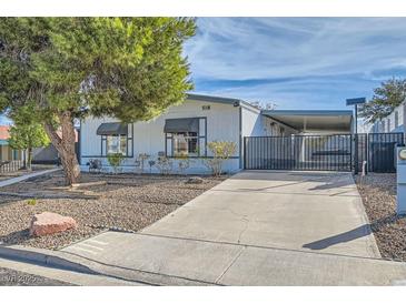 Charming single-story home featuring a well-maintained yard and a convenient covered parking area at 518 Topaz Ave, Henderson, NV 89015