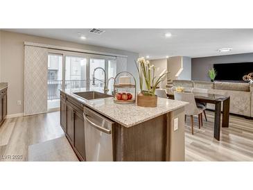 Modern kitchen with granite countertops, stainless steel appliances, and dark wood cabinetry at 6859 Crimson Shadow St, North Las Vegas, NV 89086