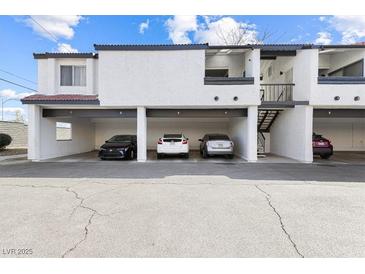 Image shows a condominium with parking spots under the units and stairs leading to the second floor at 1455 E Katie Ave # A21, Las Vegas, NV 89119