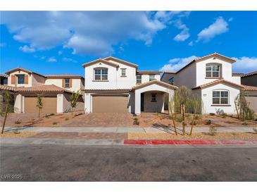 Charming, modern two-story home with a beautiful brick driveway and a well-maintained front yard on a sunny day at 186 May Park Ave, Henderson, NV 89011