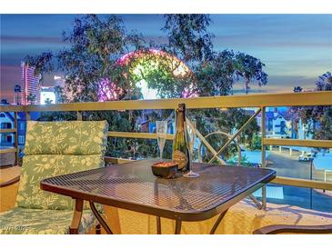 Balcony with a view of the High Roller and a table set for two with champagne at 210 E Flamingo Rd # 326, Las Vegas, NV 89169