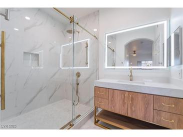 Modern bathroom with glass shower door, marble wall, and a stylish vanity with a backlit mirror at 9000 Las Vegas Blvd # 1043, Las Vegas, NV 89123