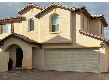 Charming two-story home featuring an attached two-car garage and an arched entry at 1034 Cantabria Heights Ave, Las Vegas, NV 89183