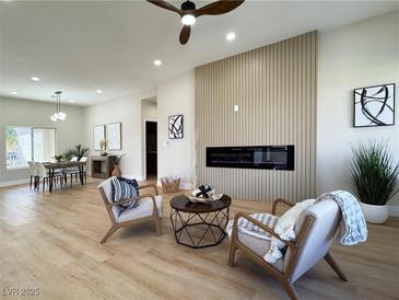 Modern living room featuring a linear fireplace, accent wall, and stylish decor at 10412 Button Willow Dr, Las Vegas, NV 89134