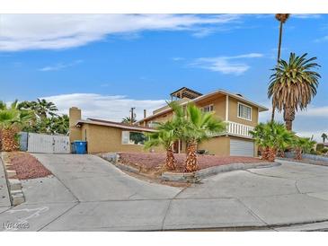 Charming home with a two-story design and mature palm trees at 1904 Chapman Dr, Las Vegas, NV 89104