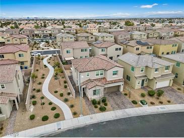 An aerial view of a residential area shows multiple two-story homes with landscaped yards and walkways at 2205 Stone Well Rd, North Las Vegas, NV 89031