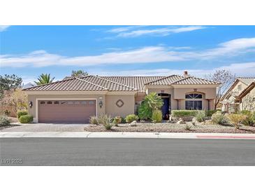 Attractive single-story home with a tile roof, desert landscaping, and a two-car garage at 2905 Haddon Dr, Las Vegas, NV 89134