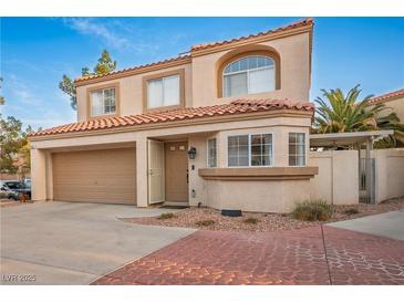 Two story home with a terracotta tile roof, stucco siding, and a two car garage at 3331 Cheltenham St, Las Vegas, NV 89129