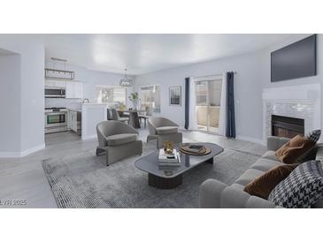Bright living room featuring modern furnishings, fireplace, and an open floor plan at 4820 Grey Wolf Ln # 101, Las Vegas, NV 89149