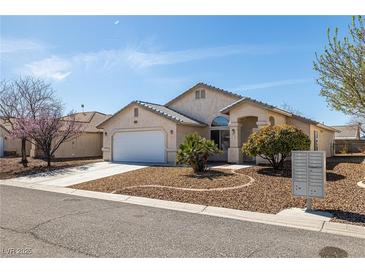 Charming single-story home featuring a two-car garage and desert landscaping at 5050 Nw Valdez Ct, Pahrump, NV 89060