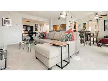 Bright living room featuring a gray sectional couch, modern decor, and an open floor plan at 737 Oakmont Ave # 1202, Las Vegas, NV 89109