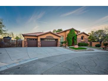 Charming single-story home with a well-manicured lawn, mature trees, and a two-car garage at 7685 Gilespie St, Las Vegas, NV 89123