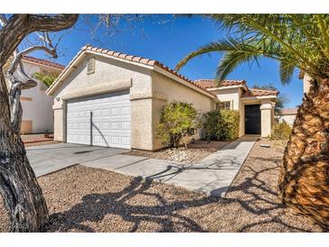 Inviting single-story home featuring desert landscaping, attached garage and neutral color palette at 8732 Majestic Pine Ave, Las Vegas, NV 89143