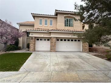 Charming two-story home with a well-manicured lawn and a spacious two-car garage at 10657 Blue Nile Ct, Las Vegas, NV 89144