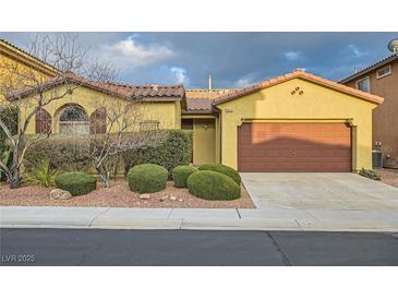 Charming single-story home featuring a terracotta tile roof and a well-manicured front yard at 10632 Open Range Ct, Las Vegas, NV 89179