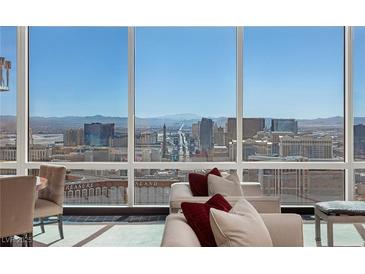 Bright living room with floor to ceiling windows offering spectacular views of the Las Vegas skyline at 2000 Fashion Show Dr # 6109, Las Vegas, NV 89109
