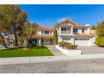 Charming two-story home featuring a red tile roof, manicured lawn, and inviting curb appeal at 3021 Ocean Port Dr, Las Vegas, NV 89117