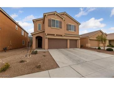 Inviting two-story home featuring a three-car garage, neutral tones, and well-kept landscaping at 3718 True Spring Pl, North Las Vegas, NV 89032