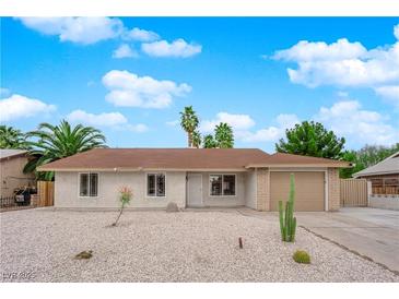 Charming single-story home featuring a desert-landscaped front yard and a neutral color scheme at 57 Marion Dr, Las Vegas, NV 89110
